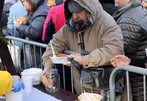 Krakow, Poland - Dec 17, 2023: Christmas Eve for poor and homeless on the Main Square in Cracow. The group Kosciuszko prepares the greatest eve in the open air in Krakow