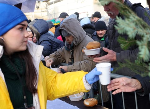Krakow, Poland - Dec 17, 2023: Christmas Eve for poor and homeless on the Main Square in Cracow. The group Kosciuszko prepares the greatest eve in the open air in Krakow