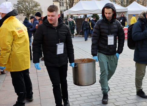 Krakow, Poland - Dec 17, 2023: Christmas Eve for poor and homeless on the Main Square in Cracow. The group Kosciuszko prepares the greatest eve in the open air in Krakow