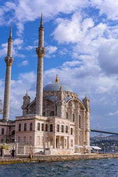 Istanbul, Turkey - November 11, 2023. Ortakoy mosque situated at the waterside of the pier. View of the Bosphorus Strait. Besiktas district, city of Istanbul, Turkey.
