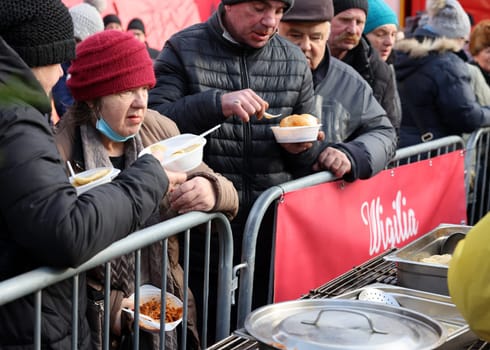Krakow, Poland - Dec 17, 2023: Christmas Eve for poor and homeless on the Main Square in Cracow. The group Kosciuszko prepares the greatest eve in the open air in Krakow