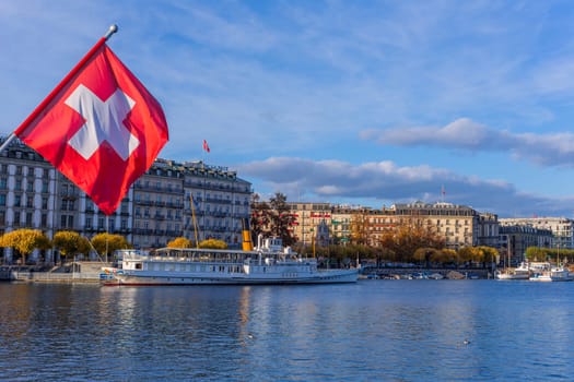 Geneva, Switzerland - November 15, 2023: Swiss flag at the Pont du Mont Blanc bridge in Geneva city in Switzerland