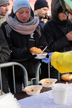Krakow, Poland - Dec 17, 2023: Christmas Eve for poor and homeless on the Main Square in Cracow. The group Kosciuszko prepares the greatest eve in the open air in Krakow