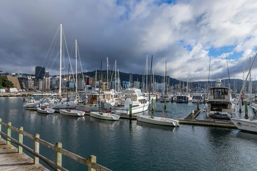 Wellington, New Zealand - 12 May 2023: Wellington Harbour with sailing boats moored at wooden bollards. Wellington, New Zealand.