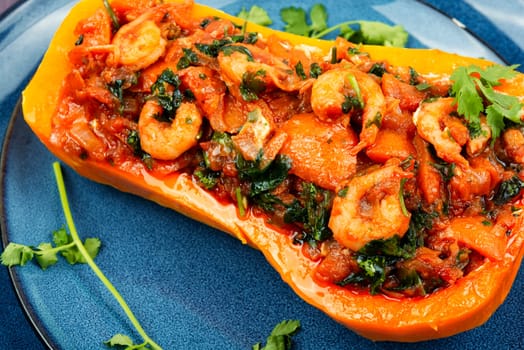 Butternut squash stuffed with peppers, tomatoes and shrimp. Brazilian dish.