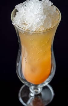 Glass of Tilt cocktail on the black background
