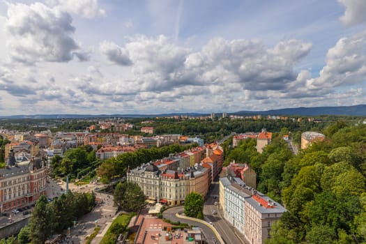 Karlovy Vary, Czech Republic: August 7, 2023. View of street with colorful riverfront houses in Czech famous spa city. Romantic architecture of Bohemia. Urban scene