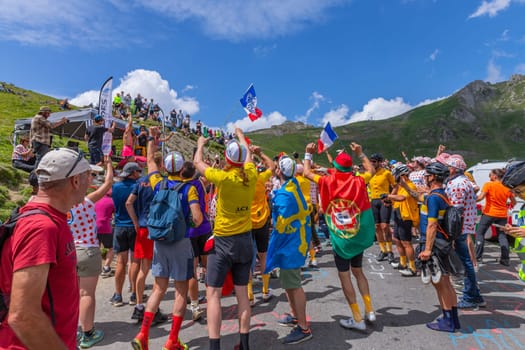 Col du Tourmalet, France - July 06 2023: Cycling fans waiting for the buch at the top of the Col du Tourmalet in Pyerenees mountains during the stage 6 of Le Tour de France 2023