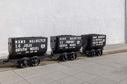 Walbrzych, Poland - October 1, 2021: The Old Mine Science and Art Centre, museum located in the historic Julia Coal Mine. Wagons with the last load of coal before closing the mine
