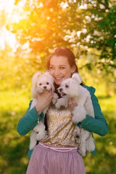 Young girl with her dog. Puppy white dog is running with it's owner. Conception about friendship, animal and freedom.