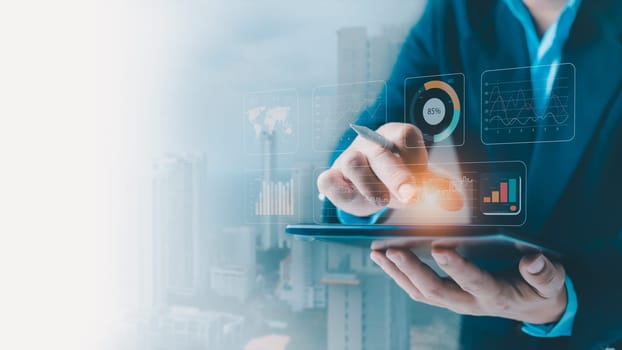 Businessman use tablets to show report graphs on the virtual screen, Business Analytics Data Management of finance work report concept,  make a report with KPI and metrics, strategy for marketing