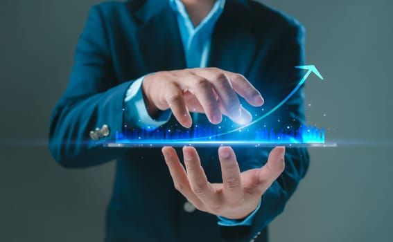 Business development concepts for success and growth. Businessman taps his finger on his phone to display a graph with percentage signs for the future growth plan of his organization. finance, management, plan, management, strategy