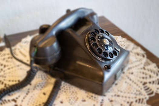 Beautiful old black telephone on a wooden table, stock photo
