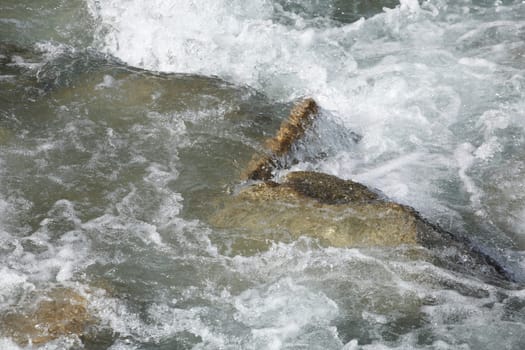 Foaming water and rocks in a river, Germany