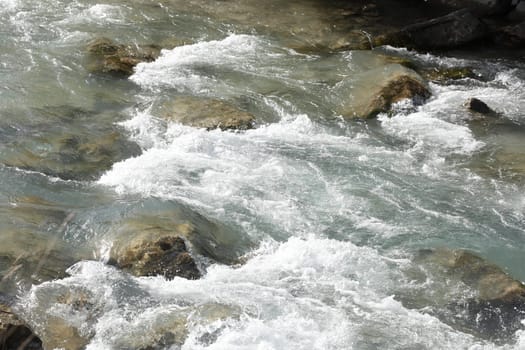 Foaming water and rocks in a river, Germany