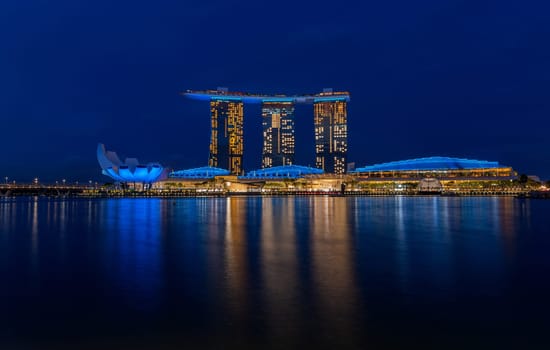 Marina Bay, Singapore - 4, June, 2023 - The view of Art Science Museum and Sands Hotel illuminated at night