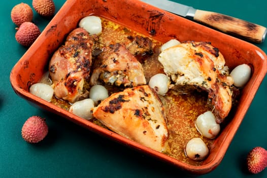 Pieces of fried chicken thighs with lychee in a baking dish. Chicken meat.