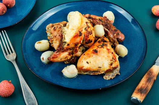 Pieces of fried chicken thighs with lychee in a baking dish. Chicken meat.