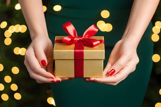Hands holding a beautifully wrapped Christmas present with bows.
