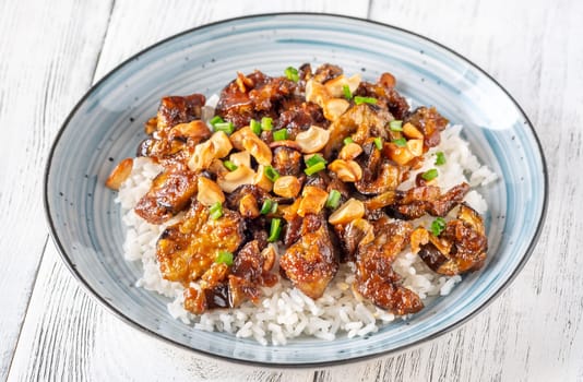 Portion of Gochujang eggplant with rice and peanuts