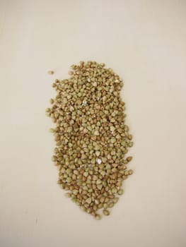 Hulled buckwheat grains on a wooden board