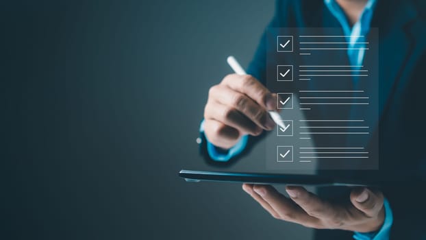 Checklist and filling survey form online. Document management system, DMS. Quality control and accuracy Check, Businessman using tablet online survey filling out, Business performance monitoring.