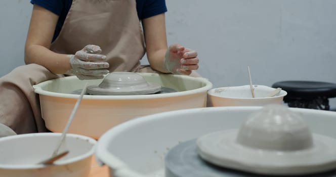 Hand work on pottery wheel, shaping a clay pot