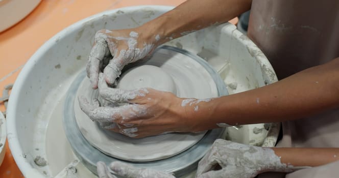 Potter making ceramic pot on the pottery wheel