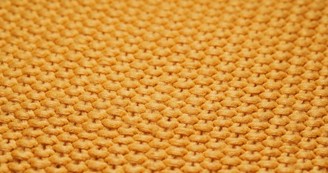 Yellow knitted duvet texture close up