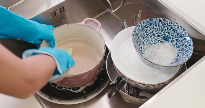 Woman wash dishes in the kitchen
