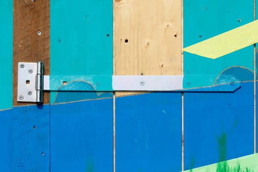 Hinge on a colorful wooden door, Germany