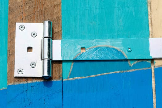 Hinge on a colorful wooden door, Germany