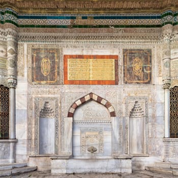 Marble fountain of Sultan Ahmed III, or Ahmet Cesmesi, a 17th century Turkish rococo water fountain, or Sebil, located in the Great Square, beside the Imperial Gate of Topkapi Palace, Istanbul, Turkey