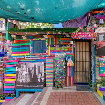 Exterior daytime shot of traditional cafe decorated with multicolored panels, movie posters and canopy in Balat District, Istanbul, Turkey