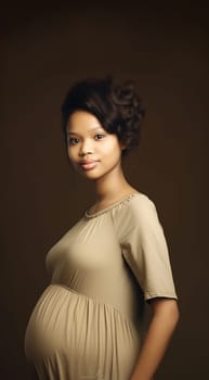 African American pregnant woman. Beautiful pregnant black woman hugging her tummy, enjoying her pregnancy, free space. Side view of African American expecting lady standing next to window at home, touching her big belly beauty shot