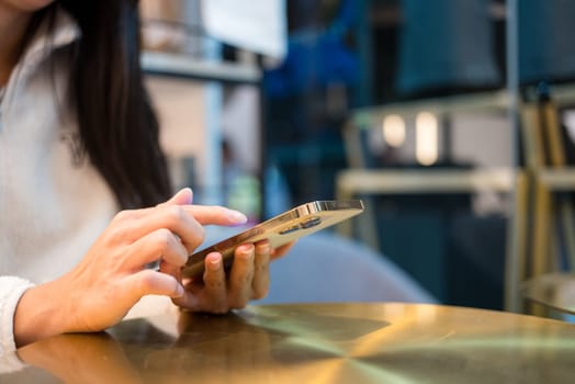 Woman use of mobile phone in cafe