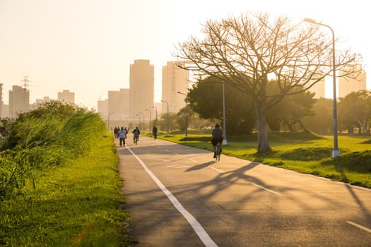 Taipei, Taiwan 07 December 2023: Riding bicycle path in Taipei city park in the evening time