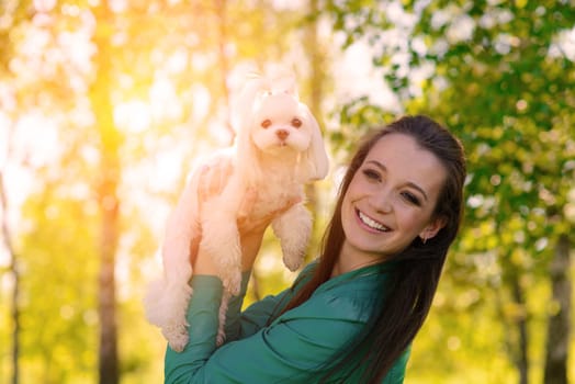 Young woman with her dog. Puppy white dog with it's owner. Concept about friendship, animal and freedom.