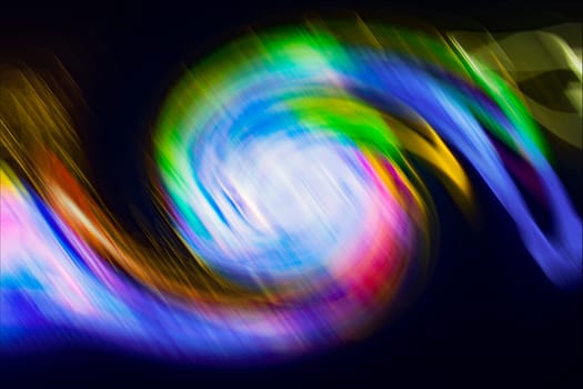 Colorful abstract spiral shape on black background.