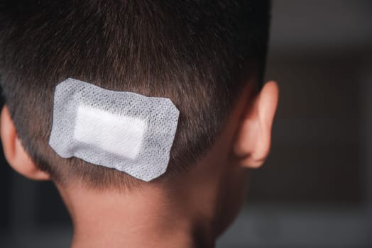 The lacerated suture wound of kid back head which suture with trauma the head by medical bandage, Medical care of the surgery lesion on the head, children of Accident