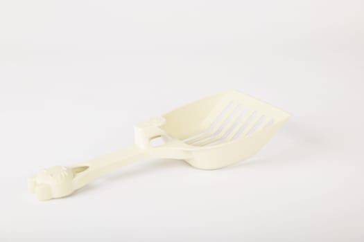 Isolated on a white background metal cat litter scoops are a must for maintaining hygiene and cleanliness in your cat's litter box. Purity and care in one simple tool.
