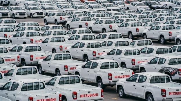 Lamchabang, Thailand - July 02, 2023 On a cloudy day at the car factory, new cars occupy rows in the distribution center. top view showcases the bustling parkinga testament to modern manufacturing.