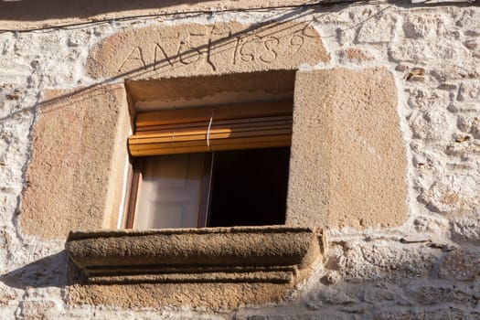 Window with lintel and carved granite sill. Perales del Puerto, beautiful little town in Sierra de Gata, Caceres, Extremadura, Spain