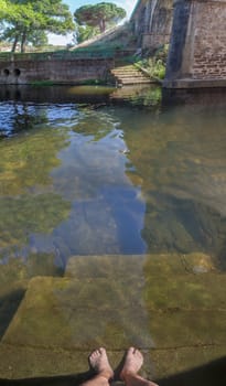 Swimmer entering at Perales del Puerto natural swimming pool. Crystal-clear waters spot in the heart of Sierra de Gata, Caceres, Extremadura, Spain