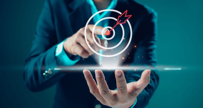 Businessman pointing finger to virtual target dart board, Success goals Targeting the business concept. Targeting the business concept.