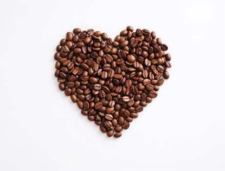 a heart of coffee beans was made on a white background.