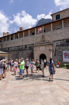 Kotor, Montenegro - June 26, 2023: View of medieval Sea Gate (Main Gate), main entrance to Old Town surrounded by Old City Walls