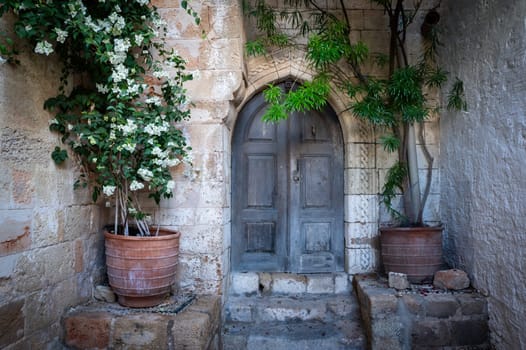 Charming old city of Lindos in Dodecanese islands. Old charming doors and flowers. Greece