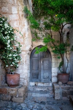 Charming old city of Lindos in Dodecanese islands. Old charming doors and flowers. Greece