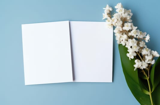 two white blank wedding cards on a blue background.